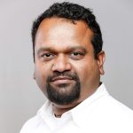 This image has an empty alt attribute; its file name is amit-shetty-2-975x1024-150x150.jpg